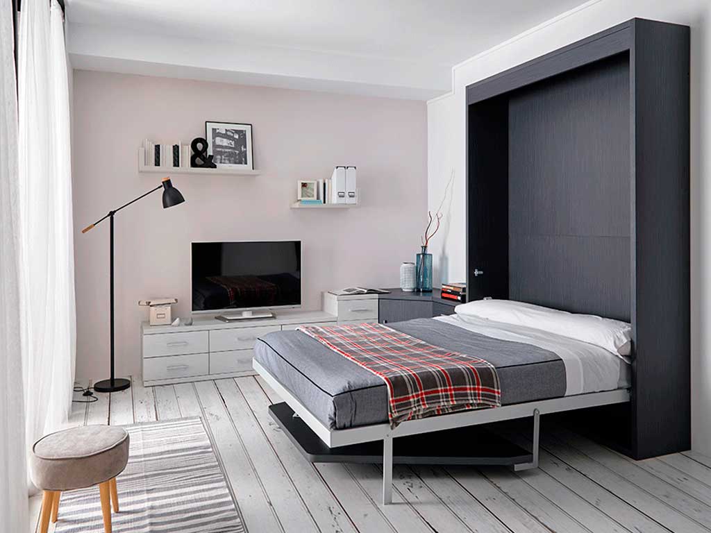 Cama abatible vertical con mesa.